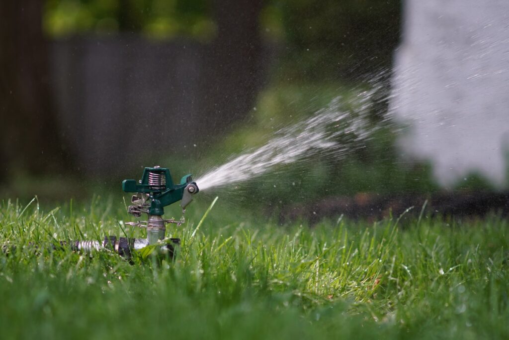 A sprinkler on a lawn for watering during the summer