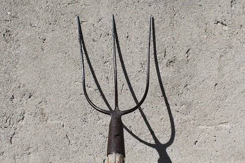 Garden fork against the wall