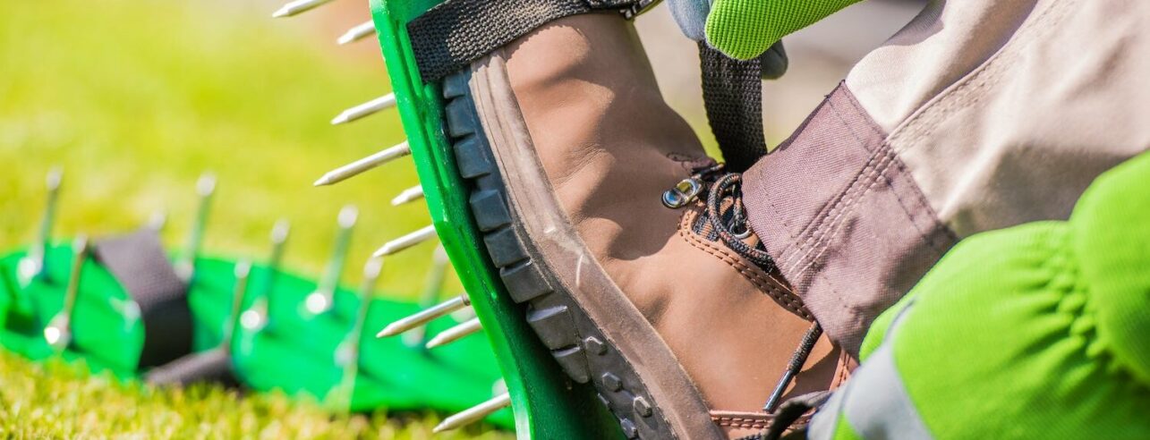 lawn aerator shoes with spikes on a lawn