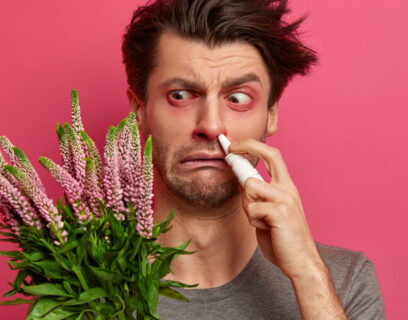 Hay fever sufferer holding flowers