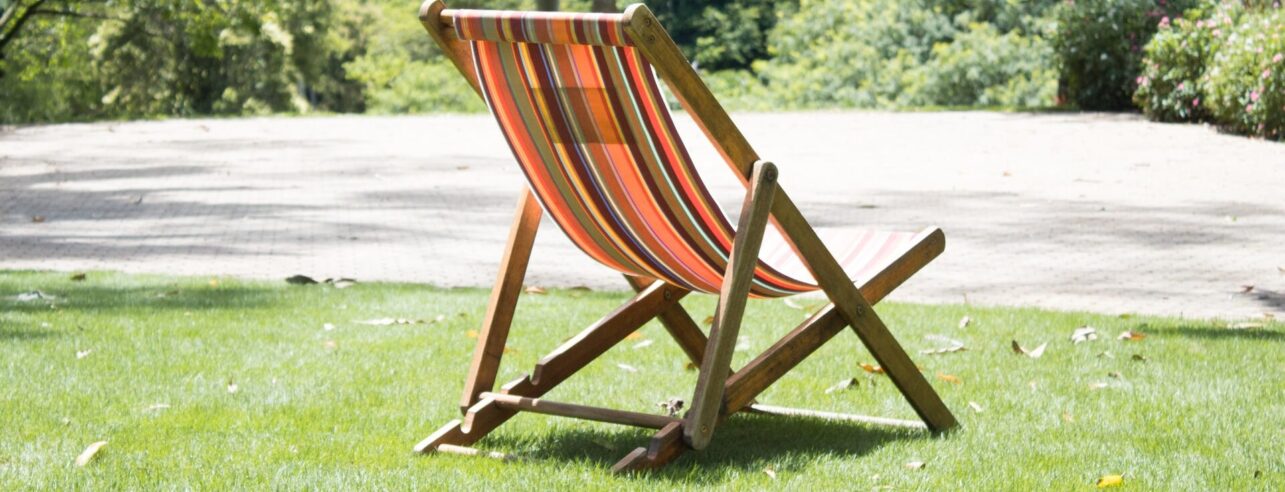 Deck chair on a summer lawn