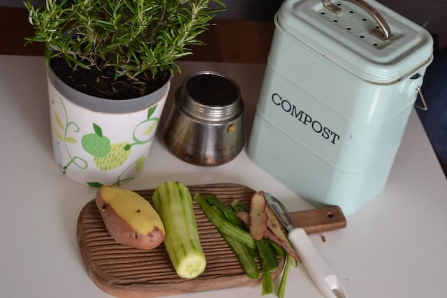 Veg on a chopping board with a compost bin