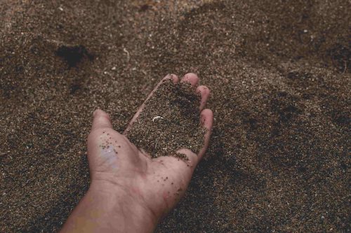 Light sandy soil held in a hand