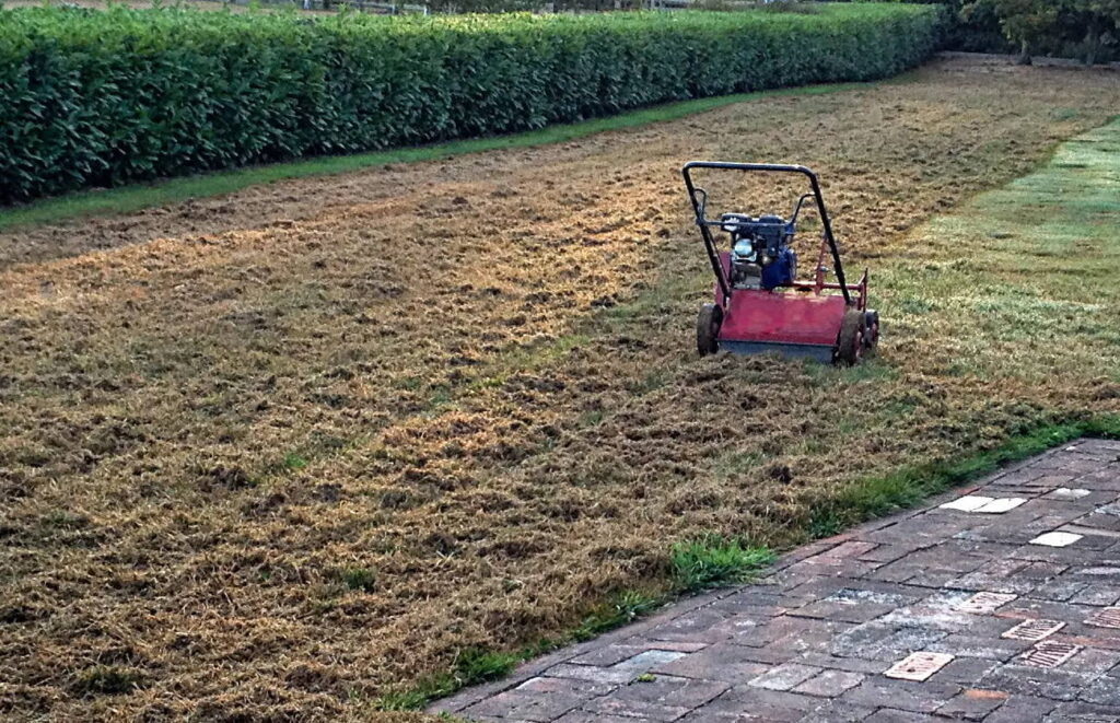 A scarifying machine on a large lawn.
