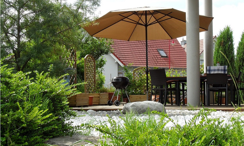 A garden terrace with sun shade and seating. 