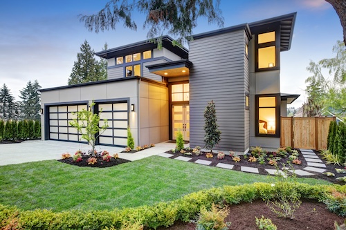 A lovely modern front garden with double garage.