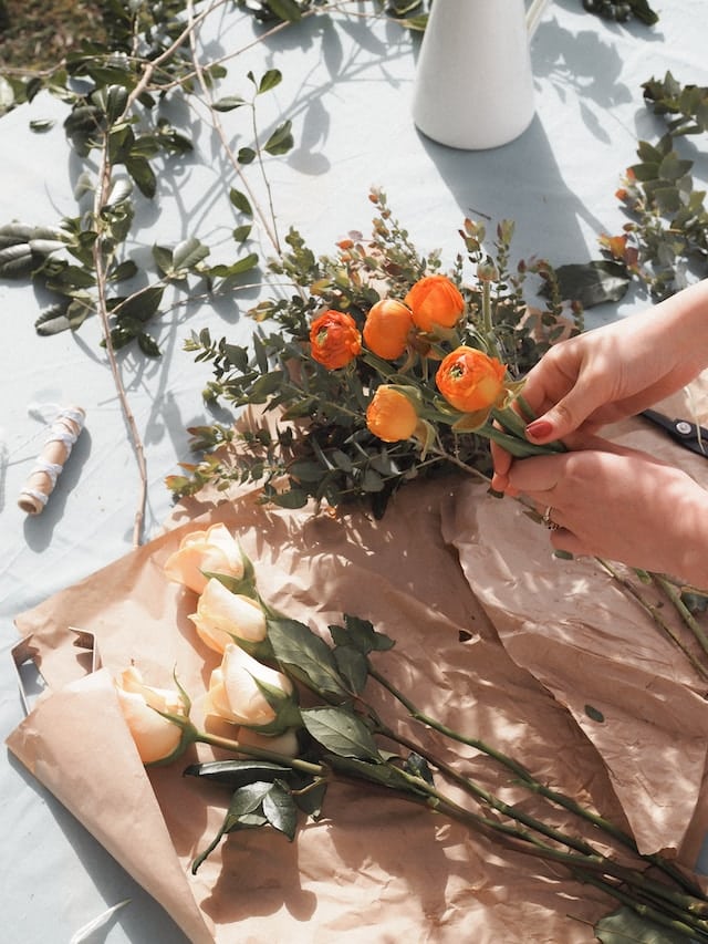 A woman choosing flowers for an arrangement