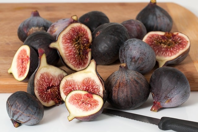 A selection of halved and whole ripe figs